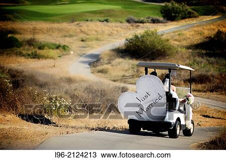 bride and groom escaping in a golf cart with a sign on the back? just married? View Large Photo Image Stock Image - bride and groom escaping in a golf cart with a sign on the back? just married?. Fotosearch