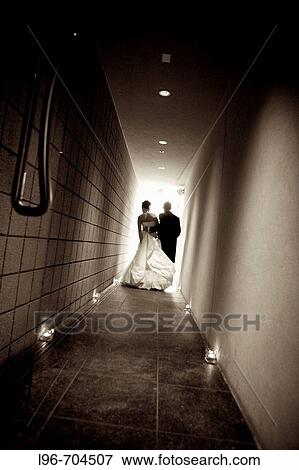 bride and groom escaping together after the wedding reception View Large Photo Image Stock Photo - bride and groom escaping together after the wedding reception. Fotosearch