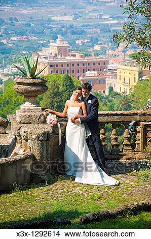 Bride and groom holding eachother over the panorama of Rome View Large Photo Image Picture - Bride and groom holding eachother over the panorama of Rome. Fotosearch