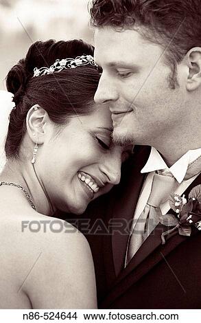 Picture - Bride and groom hugging. Fotosearch