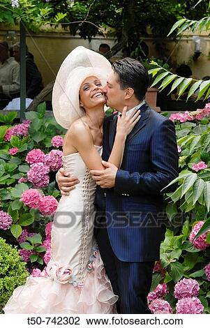 Bride and Groom in flowers garden View Large Photo Image Stock Image - Bride and Groom in flowers garden. Fotosearch