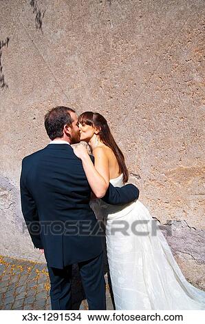 Bride and groom kissing after wedding View Large Photo Image Picture - Bride and groom kissing after wedding. Fotosearch