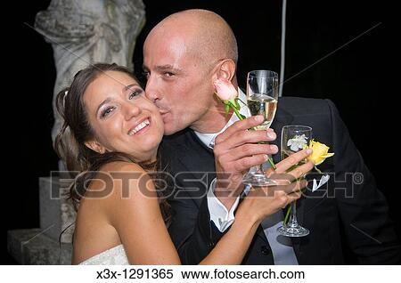 Bride and groom kissing at the toast View Large Photo Image Stock Photography - Bride and groom kissing at the toast. Fotosearch
