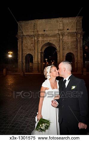 Bride and Groom kissing by the Constantine's Arch in Rome Italy View Large Photo Image Stock Photography - Bride and Groom kissing by the Constantine's Arch in Rome Italy. Fotosearch