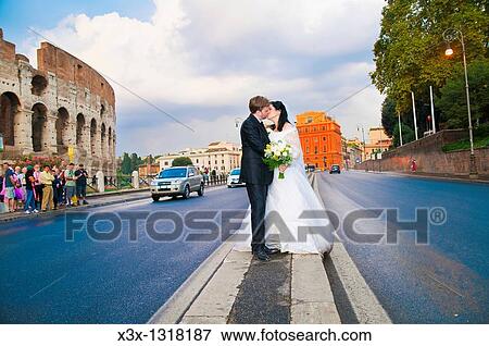 Bride and groom kissing in the streets of Rome Italy View Large Photo Image Stock Photo - Bride and groom kissing in the streets of Rome Italy. Fotosearch