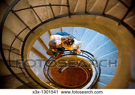 Bride and groom kissing on spiral stairs View Large Photo Image Stock Image - Bride and groom kissing on spiral stairs. Fotosearch