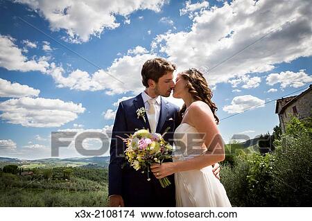 Picture - Bride and groom kissing.. Fotosearch
