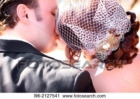Stock Image - bride and groom kissing. Fotosearch