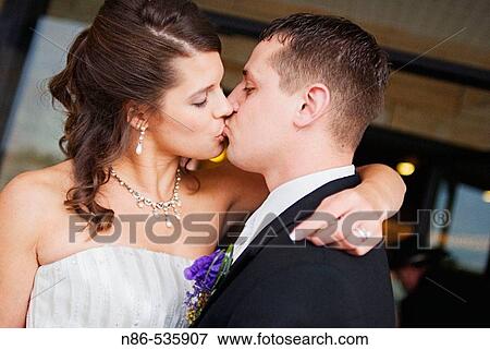 Bride and groom kissing View Large Photo Image Stock Photo - Bride and groom kissing. Fotosearch