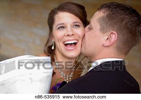 Stock Photography - Bride and groom kissing. Fotosearch