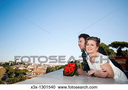 Bride and groom overlooking Rome from the balcony of Giardino degli Aranci, Rome Italy View Large Photo Image Stock Image - Bride and groom overlooking Rome from the balcony of Giardino degli Aranci, Rome Italy. Fotosearch