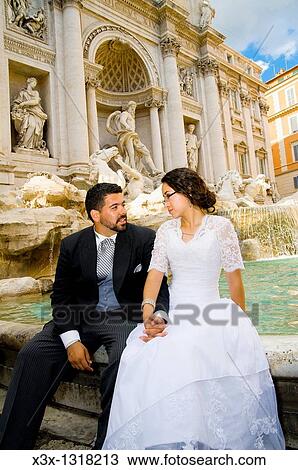 Bride and groom posing in front of Trevi Fountain, Rome, Italy View Large Photo Image Stock Image - Bride and groom posing in front of Trevi Fountain, Rome, Italy. Fotosearch