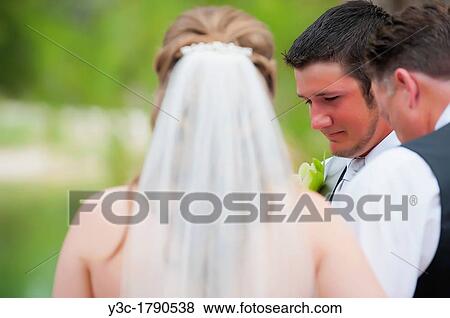 Bride and groom praying at their outdoor wedding View Large Photo Image Stock Photo - Bride and groom praying at their outdoor wedding. Fotosearch