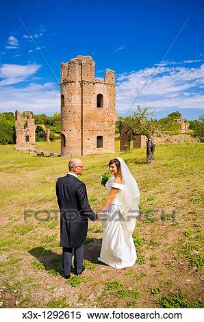 Bride and groom psing among ancient remains of Villa di Massenzio in Rome Italy View Large Photo Image Stock Photography - Bride and groom psing among ancient remains of Villa di Massenzio in Rome Italy. Fotosearch