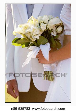 Bride and groom shot of hands and flowers View Large Photo Image Stock Image - Bride and groom shot of hands and flowers. Fotosearch