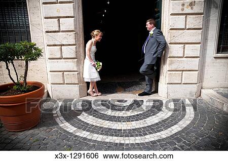 Bride and groom standing together outside Tivoli Town Hall Italy View Large Photo Image Stock Photograph - Bride and groom standing together outside Tivoli Town Hall Italy. Fotosearch