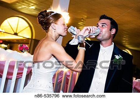 Bride and groom toasting each other View Large Photo Image Stock Photograph - Bride and groom toasting each other. Fotosearch