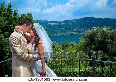 Bride and groom together by an Italian lake View Large Photo Image Stock Image - Bride and groom together by an Italian lake. Fotosearch
