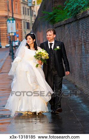 Bride and groom walking together in the street View Large Photo Image Stock Photography - Bride and groom walking together in the street. Fotosearch