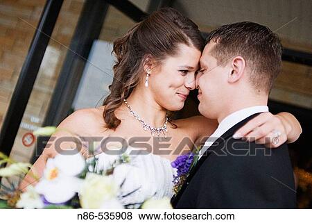 Bride and groom with heads together View Large Photo Image Stock Photo - Bride and groom with heads together. Fotosearch