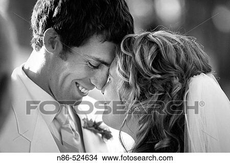 Picture - Bride and groom with heads touching. Fotosearch