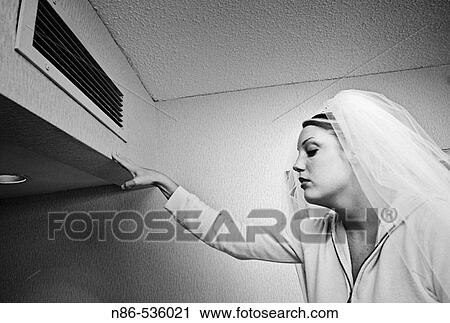 Bride cooling off under air conditioning vent View Large Photo Image Stock Image - Bride cooling off under air conditioning vent. Fotosearch