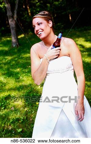 Bride cooling off with cold beer View Large Photo Image Stock Image - Bride cooling off with cold beer. Fotosearch