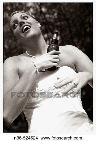 Bride drinking beer View Large Photo Image Picture - Bride drinking beer. Fotosearch