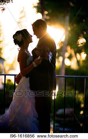 bride groom embracing at sunset after wedding View Large Photo Image Stock Photograph - bride groom embracing at sunset after wedding. Fotosearch