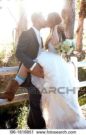 bride groom happy kissing at sunset after wedding View Large Photo Image Stock Image - bride groom happy kissing at sunset after wedding. Fotosearch