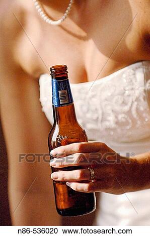 Bride holding a beer View Large Photo Image Stock Image - Bride holding a beer. Fotosearch