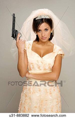 Stock Image - Bride holding a gun. Fotosearch