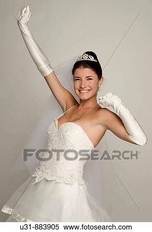 Bride in her 20s celebrates in a studio setting View Large Photo Image Stock Photography - Bride in her 20s celebrates in a studio setting. Fotosearch