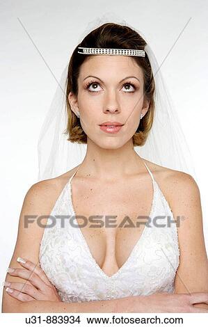 Bride in her 20s looking up thinking View Large Photo Image Picture - Bride in her 20s looking up thinking. Fotosearch