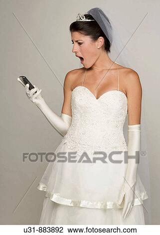 Bride in her 20s looks amazed/disgusted at cell phone View Large Photo Image Stock Image - Bride in her 20s looks amazed/disgusted at cell phone. Fotosearch