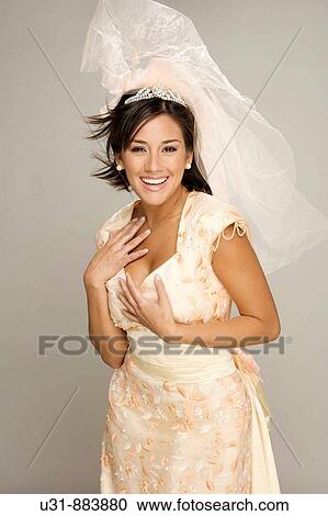 Bride in her 20s smiles at the camera in a studio setting View Large Photo Image Stock Image - Bride in her 20s smiles at the camera in a studio setting. Fotosearch