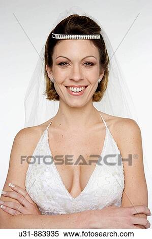 Bride in her 20s smiles at the camera in a studio setting View Large Photo Image Stock Photography - Bride in her 20s smiles at the camera in a studio setting. Fotosearch
