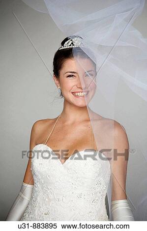 Bride in her 20s smiles under her veil View Large Photo Image Stock Photography - Bride in her 20s smiles under her veil. Fotosearch