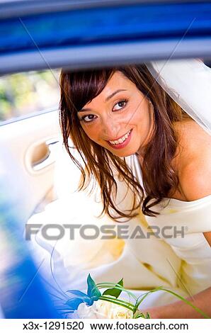 Bride in wedding car View Large Photo Image Stock Image - Bride in wedding car. Fotosearch