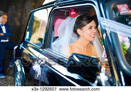 Bride in wedding car View Large Photo Image Stock Photo - Bride in wedding car. Fotosearch