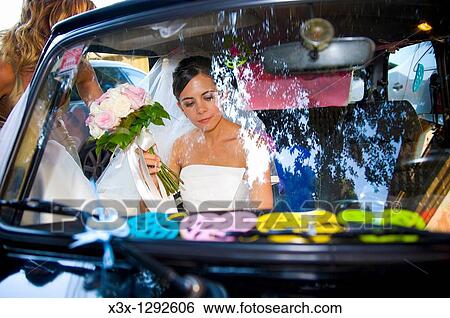 Bride in wedding car View Large Photo Image Stock Photograph - Bride in wedding car. Fotosearch