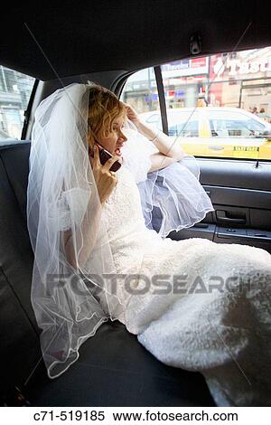 Bride in wedding dress in car talking on cell phone View Large Photo Image Stock Photography - Bride in wedding dress in car talking on cell phone. Fotosearch
