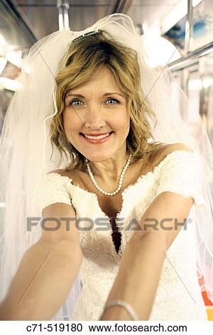 Bride in wedding dress in subway car smiling in camera View Large Photo Image Stock Image - Bride in wedding dress in subway car smiling in camera. Fotosearch