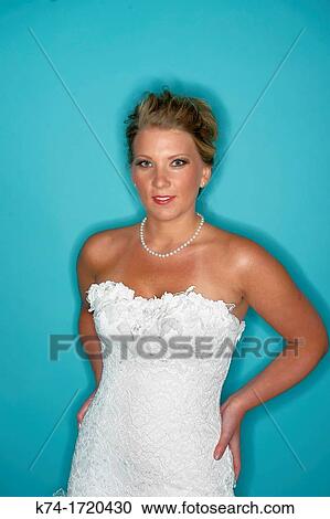 Bride in wedding dress shot with ring flash against blue background View Large Photo Image Stock Image - Bride in wedding dress shot with ring flash against blue background. Fotosearch