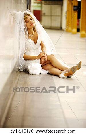 Bride in wedding dress sitting on subway station floor dreaming View Large Photo Image Stock Photograph - Bride in wedding dress sitting on subway station floor dreaming. Fotosearch