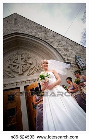 Bride outside church with veil blowing View Large Photo Image Stock Image - Bride outside church with veil blowing. Fotosearch