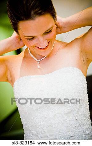 bride putting on a necklace View Large Photo Image Picture - bride putting on a necklace. Fotosearch