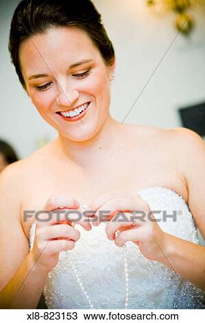 bride putting on a necklace View Large Photo Image Stock Image - bride putting on a necklace. Fotosearch