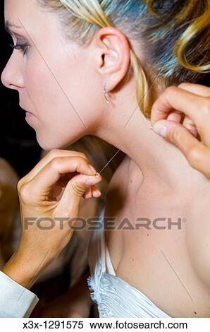 Bride putting on necklace View Large Photo Image Stock Photography - Bride putting on necklace. Fotosearch