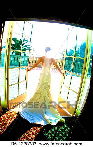 Stock Photo - bride ready for her wedding walking out the doors. Fotosearch